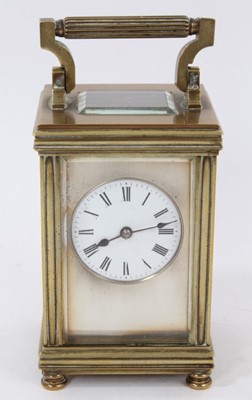 Lot 654 - Edwardian brass carriage clock with circular enamel dial