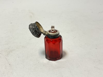Lot 120 - Victorian ruby glass scent bottle with floral embossed silver top