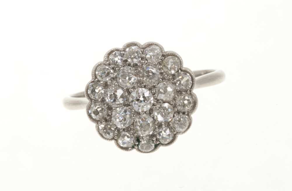 Lot 425 - Antique diamond cluster ring with a flower head cluster of pavé set old cut diamonds in platinum setting