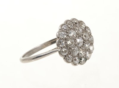 Lot 425 - Antique diamond cluster ring with a flower head cluster of pavé set old cut diamonds in platinum setting