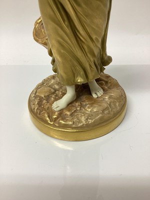 Lot 62 - An early 20th century Royal Worcester figure of a musician, modelled in gilt as a lady with a drum, signed Hadley with puce mark to base and number 1567