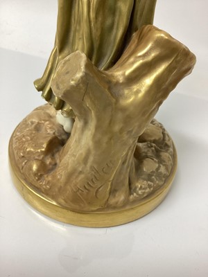 Lot 62 - An early 20th century Royal Worcester figure of a musician, modelled in gilt as a lady with a drum, signed Hadley with puce mark to base and number 1567