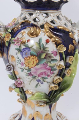 Lot 86 - An Imperial Russian Garner Factory porcelain lidded vase, circa 1900, with pierced decoration and hand painted central panels with individual applied flowers, blue mark to base, 39cm tall