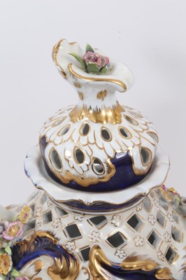 Lot 86 - An Imperial Russian Garner Factory porcelain lidded vase, circa 1900, with pierced decoration and hand painted central panels with individual applied flowers, blue mark to base, 39cm tall