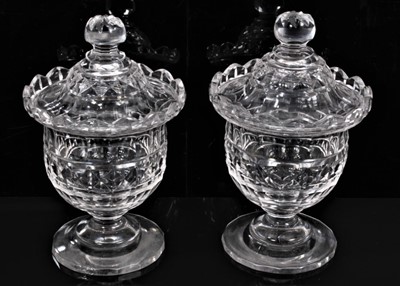 Lot 66 - A pair of 19th century cut glass sweet meats/bonbonnieres and covers, with wavy rims, diamond, facet-cut and other patterns, on circular bases, 16.5cm high