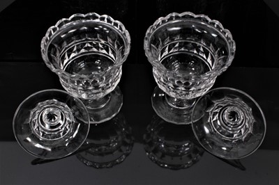Lot 66 - A pair of 19th century cut glass sweet meats/bonbonnieres and covers, with wavy rims, diamond, facet-cut and other patterns, on circular bases, 16.5cm high