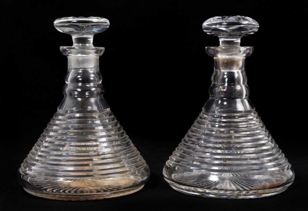 Lot 69 - A near pair of 19th century cut glass ship's decanters, with banded decoration to the bodies, 23cm high