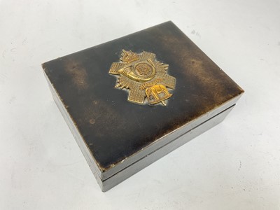 Lot 499 - Military interest- good quality leather cigar box with applied brass regimental badge for the Highland Light Infantry, 19 x 15cm