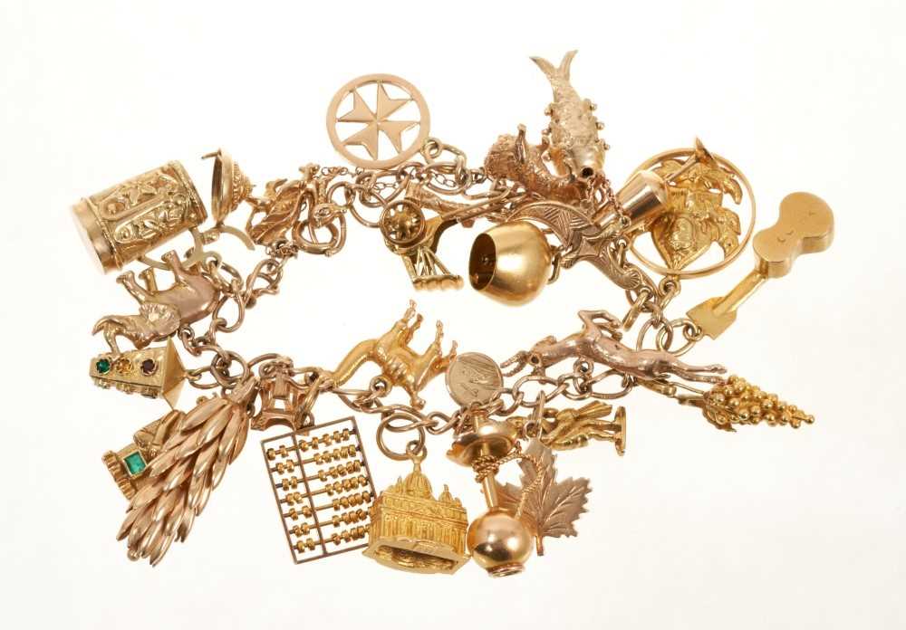 Lot 415 - 9ct gold charm bracelet with a collection of twenty-six various carat gold and yellow metal charms