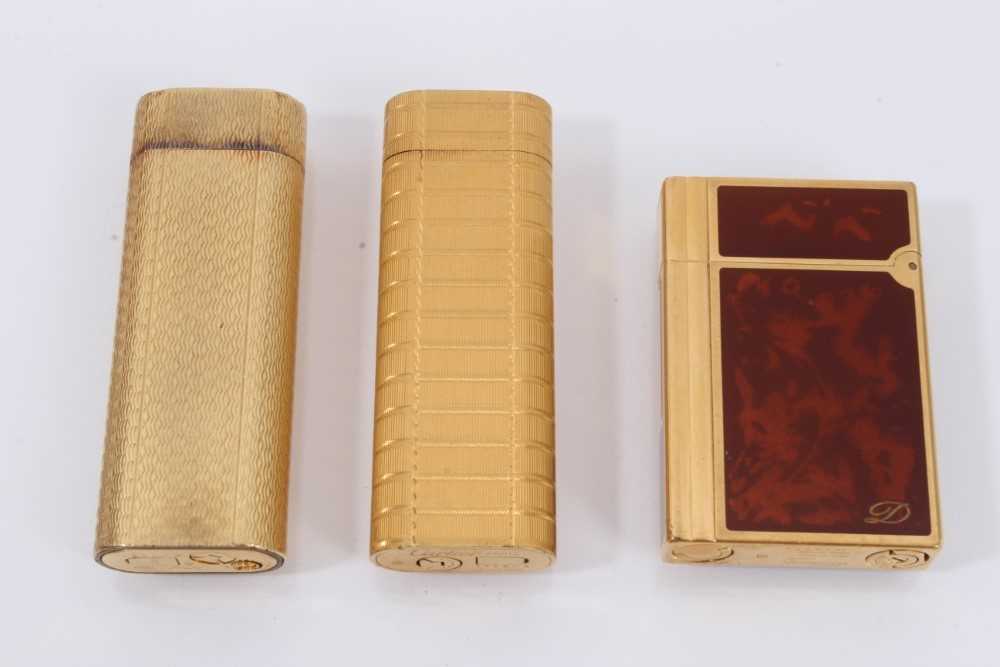 Lot 535 - Two vintage Cartier lighters and a Dupont lighter