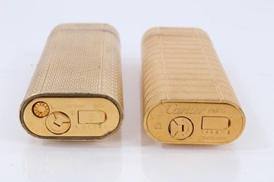 Lot 535 - Two vintage Cartier lighters and a Dupont lighter