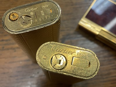 Lot 535 - Two vintage Cartier lighters and a Dupont lighter