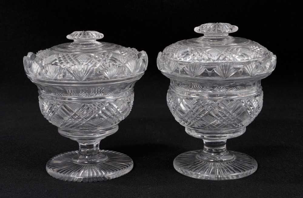 Lot 78 - A near pair of 19th century cut glass covered vases, with cross-hatched and diamond pattern, fan-pattern border, 13.5cm and 14.5cm high