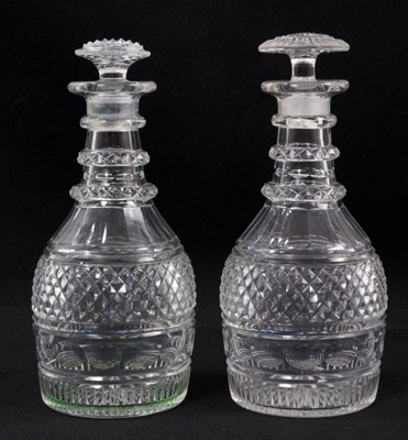 Lot 79 - A near pair of Georgian cut glass three-ring decanters, with diamond and facet-cut patterns, mushroom stoppers, 20.5cm and 21cm high