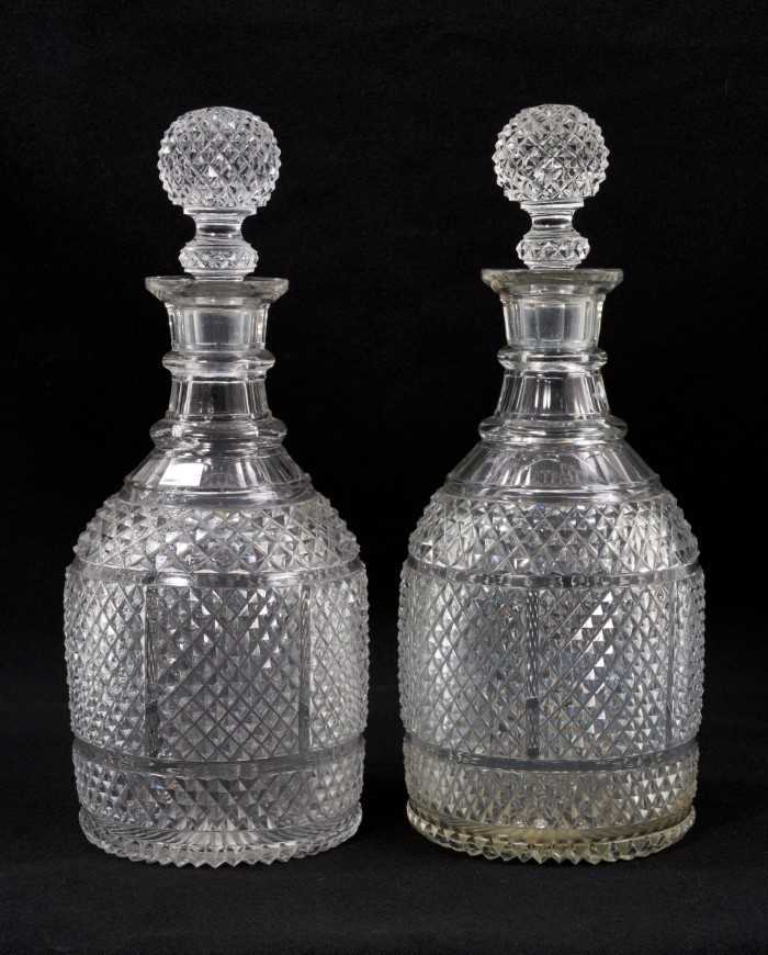 Lot 82 - A pair of 19th century ovoid-form two-ring diamond-cut glass decanters with globe stoppers, 28cm high