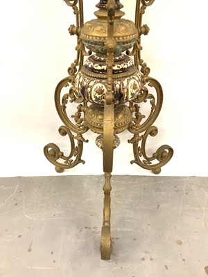Lot 88 - A 19th century continental pottery and brass jardinière on stand, possibly Austrian, decorated with foliate patterns and cherubs in shades of brown and blue, standing on three scrolled brass legs,...