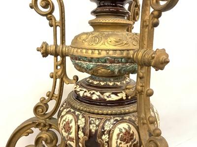 Lot 88 - A 19th century continental pottery and brass jardinière on stand, possibly Austrian, decorated with foliate patterns and cherubs in shades of brown and blue, standing on three scrolled brass legs,...