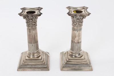 Lot 284 - Pair of late Victorian silver Corinthian column candlesticks