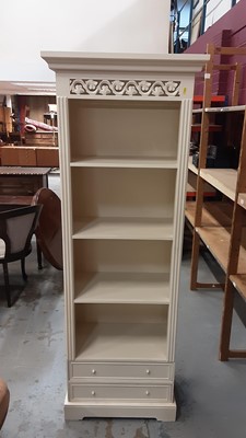 Lot 1004 - Contemporary cream open bookcase with two drawers below, 65cm wide, 40cm deep, 180.5cm high