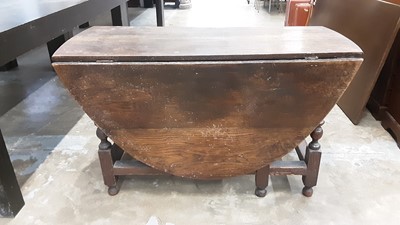 Lot 1018 - Antique oak oval drop leaf table with end drawer on bobbin turned and block legs, opening to 124cm x 162cm