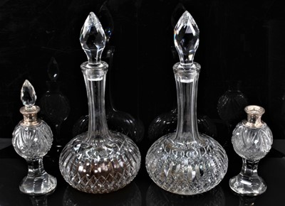 Lot 92 - A pair of Webb cut glass shaft and globe decanters, 31cm high, together with a pair of small silver mounted cut glass bottles (one stopper missing)