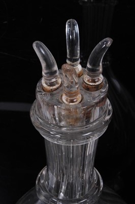Lot 94 - An unusual pair of French glass decanters, each internally divided into four parts, with individual stoppers, 31cm high