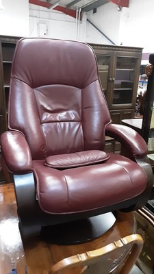 Lot 1032 - Contemporary leather reclining armchair with matching footstool