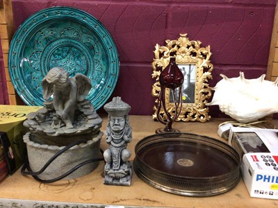 Lot 696 - Electric water fountain feature with Cherub, plated circular coaster, shell table light, wooden mantle clock, orientalist cork displays, carved wooden girls head plaque, brass wear and other sundry...
