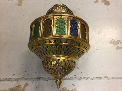 Lot 698 - Indian style pierced brass pendent lantern with coloured glass panel and a pair of matching wall lights