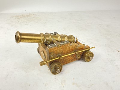 Lot 663 - Miniature model of a signalling cannon on oak gun carriage.