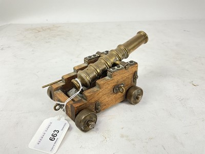 Lot 663 - Miniature model of a signalling cannon on oak gun carriage.