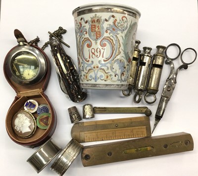 Lot 853 - WWII G.S/T.P military pocket watch, cameo brooch, Victorian enamel commemorative beaker, multi blade pocket knife, silver napkin ring and thimble, whistles and sundry items