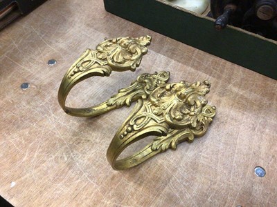 Lot 54 - A pair of antique French ormolu tie backs, stamped marks to back, 18.5cm long