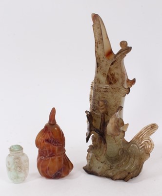 Lot 790 - Chinese russet jade carving of a pike in waves, 20cm high, together with carved jade snuff bottle and stopper and a carving of a fruit. (3)