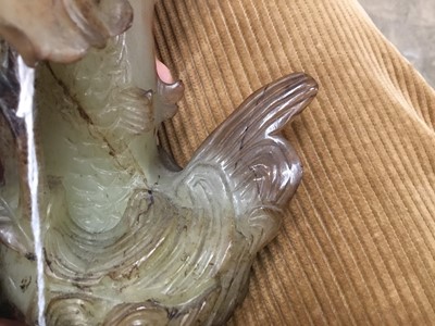 Lot 790 - Chinese russet jade carving of a pike in waves, 20cm high, together with carved jade snuff bottle and stopper and a carving of a fruit. (3)