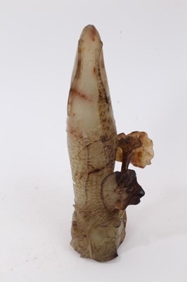 Lot 790 - Chinese russet jade carving of a pike in waves, 20cm high, together with carved jade snuff bottle and stopper and a carving of a fruit. (3)