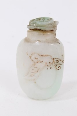 Lot 790 - Chinese russet jade carving of a pike in waves, 20cm high, together with carved jade snuff bottle and stopper and a carving of a fruit. (3)