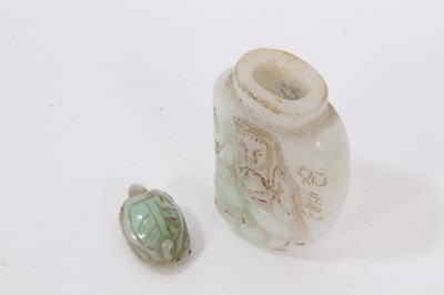 Lot 790 - Chinese russet jade carving of a pike in waves, 20cm high, together with carved jade snuff bottle and stopper and a carving of a fruit. (3)