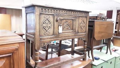 Lot 1049 - Seventeenth century style oak sideboard with carved decoration and panelled door on turned and block legs joined by stretchers, 91cm wide, 35cm deep, 76cm high