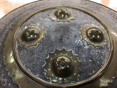 Lot 62 - 19th century Islamic brass shield with engraved decoration, leather handle, 36.5cm diameter