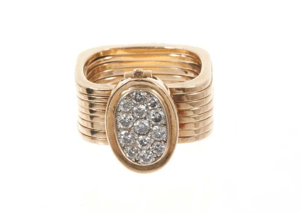 Lot 534 - Unusual diamond and gold combination ring and bracelet, the ring composed of eight square sections which unfold to form a bracelet, the pavé set diamond oval bezel forming the clasp.