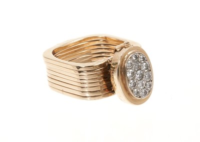 Lot 534 - Unusual diamond and gold combination ring and bracelet, the ring composed of eight square sections which unfold to form a bracelet, the pavé set diamond oval bezel forming the clasp.