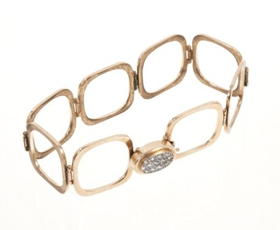 Lot 534 - Unusual diamond and gold combination ring and bracelet, the ring composed of eight square sections which unfold to form a bracelet, the pavé set diamond oval bezel forming the clasp.