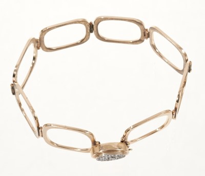 Lot 534 - Unusual diamond and gold combination ring and bracelet, the ring composed of eight square sections which unfold to form a bracelet, the pavé set diamond oval bezel forming the clasp.