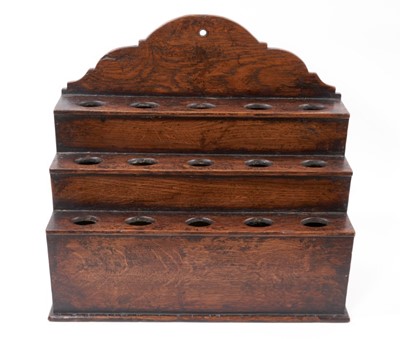 Lot 849 - George III tiered oak spoon rack with fifteen apertures and a shaped top on a plinth base