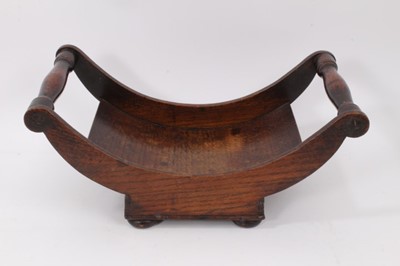 Lot 848 - George III oak cheese coaster with turned handles on square base with bun feet