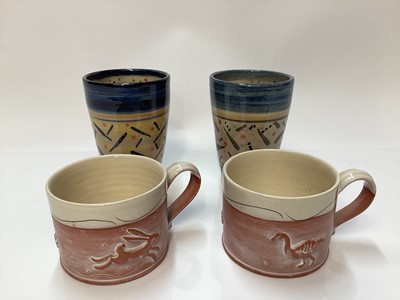 Lot 1141 - Two studio pottery mugs by Philip Wood and two decorated beakers signed “Still”.