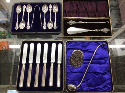 Lot 859 - Set of six silver teaspoons and sugar tongs, cased silver handled button hook and shoe horn, cased set of silver handled knives, white metal ladle and an antique purse