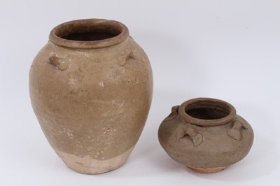 Lot 118 - Two early Chinese glazed pots with lugs around the shoulders