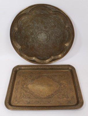 Lot 874 - Two Islamic engraved brass trays